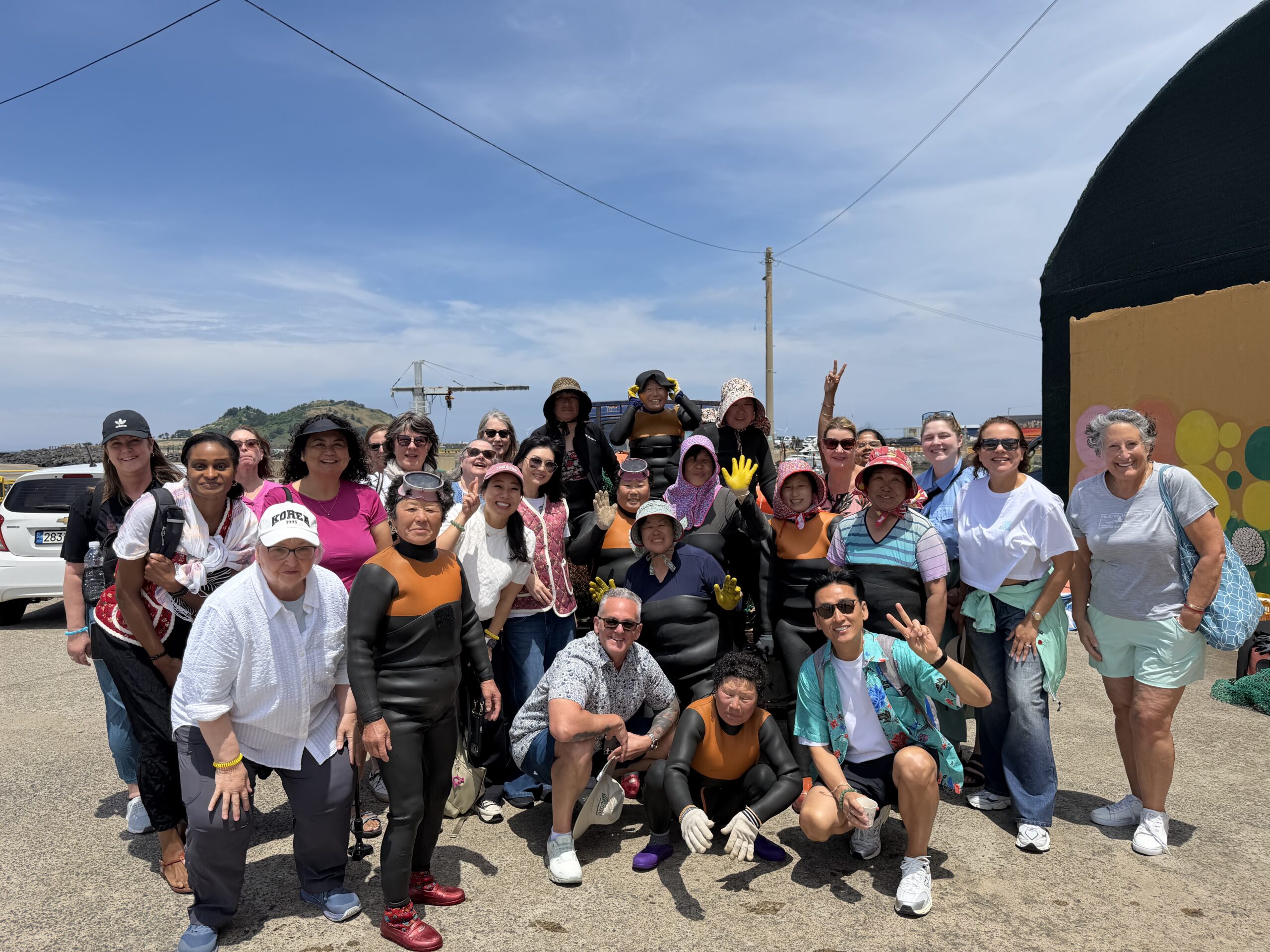 Tour participants and local divers bonding during the Meet You In Korea K-Drama Healing Reunion Tour: Coastal Edition – Spring 2026.